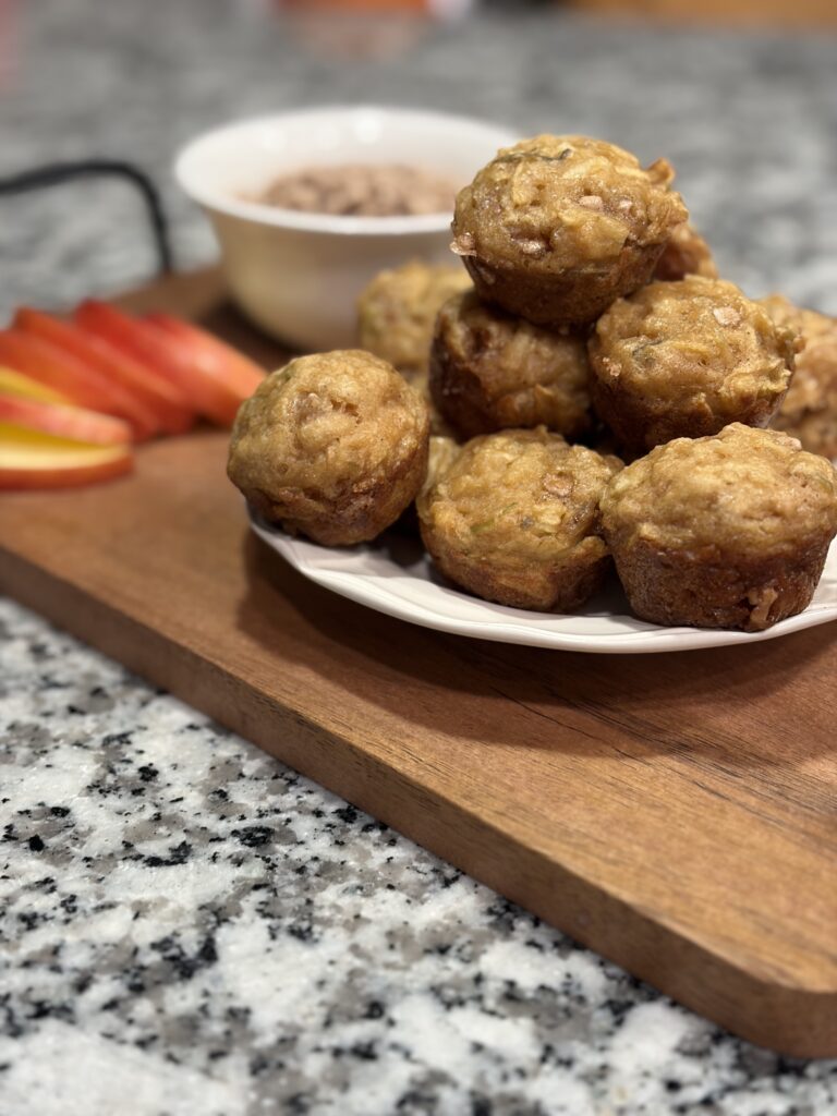 Close-up of apple cinnamon chip mini muffins stacked on a plate