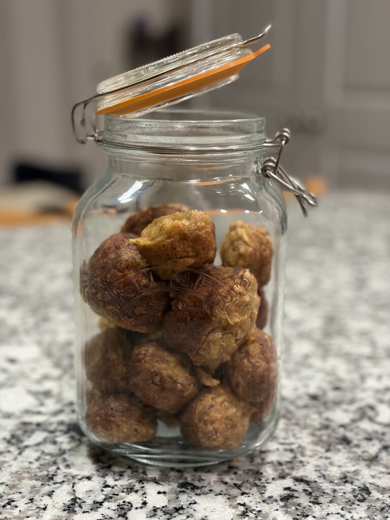 Apple cinnamon chip mini muffins stored in a glass jar