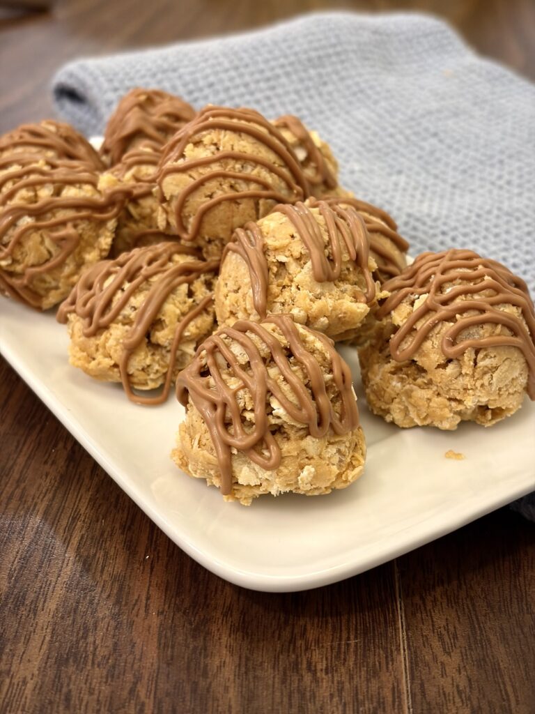 Scotcharoo protein balls drizzled with chocolate and butterscotch